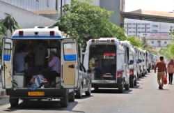 Ambulances carrying COVID-19 patients line up waiting for their turn to be attended to at a dedicated COVID-19 government hospital in Ahmedabad, India, April 22, 2021. Indian authorities scrambled Saturday to get oxygen tanks to hospitals.