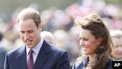 Britain's Prince William walks with his fiancee, Kate Middleton, during their visit to Witton Country Park in Darwen, northern England, April 11, 2011