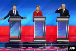 Democratic presidential candidates former South Bend, Indiana Mayor Pete Buttigieg, left, Sen. Elizabeth Warren (D-MA) and former Vice President Joe Biden participate in the Democratic presidential primary debate, Feb. 7, 2020, in Manchester, N.H.