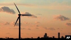 FILE - A wind turbine stands, generating power next to Hull, Massachusetts, Feb. 24, 2006.