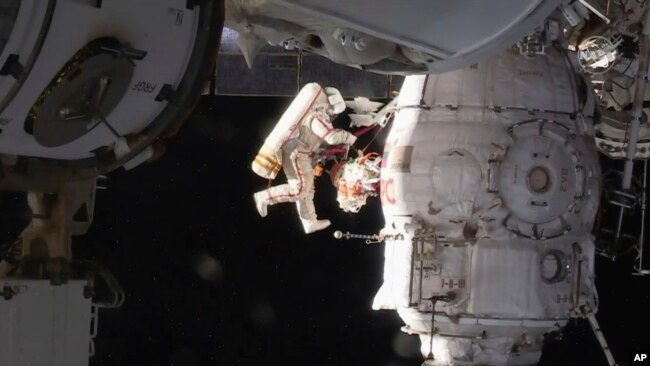 In this image from video made available by NASA, Russian cosmonaut Oleg Kononenko performs a spacewalk outside the International Space Station, Dec. 11, 2018.