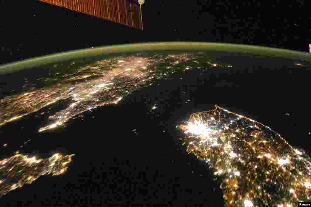 Photo taken by the Expedition 38 crew aboard the International Space Station (ISS) on January 30, 2014 shows the night view of the Korean Peninsula, and North Korea in the middle is almost completely dark compared to neighboring South Korea (bottom right) and China (top left).