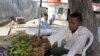 FILE - A youth sits beside bundles of khat that he sells for his employer in Mogadishu, Somalia, July 12, 2012.