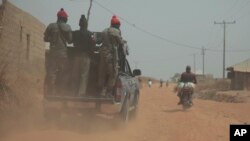 Security officers patrol the area near to the site where gunmen abducted German archaeologists professor Peter Breunig and his associate Johannes Behringer in Janjala Village, Nigeria, Feb. 24, 2017.