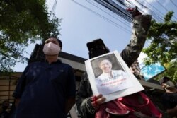 Activists gather for a rally with a photo of Thai dissident Wanchalearm Satsaksit in front of Cambodian Embassy in Bangkok, Thailand, June 8, 2020.