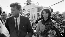 President John F. Kennedy and his wife Jacqueline Kennedy are greeted by an enthusiastic crowd upon their arrival at Dallas Love Field, Texas, Nov. 22, 1963.