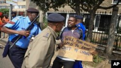 FILE - A protester is detained by police during a demonstration against the Finance Bill, in downtown Nairobi, Kenya Tuesday, June 13, 2023. 