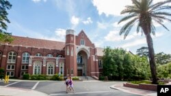FILE - Students are seen walking on the campus of Florida State University in Tallahassee, Florida, April 30, 2015.