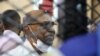 FILE - In this Sept. 15, 2020 file photo, Sudan's ousted president Omar al-Bashir sits at the defendant's cage during his trial a courthouse in Khartoum, Sudan, Sept. 15, 2020. 