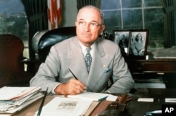 FILE - This 1948 portrait of Harry S. Truman at his White House office desk.