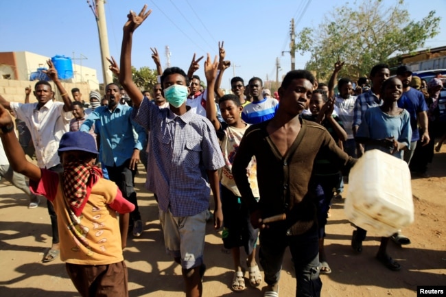 FILE - Sudanese demonstrators march during anti-government protests in Khartoum, Sudan, Jan. 24, 2019.