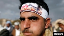 FILE - A Houthi supporter wears a headband praising the Houthi movement for making drone aircraft as he attends a pro-Houthi rally in Sana'a, Yemen March 3, 2017. 