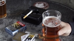 Cigarette packs with graphic health pictures on a table at a pub in Sydney, Australia, in July