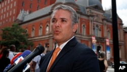FILE - Colombia's President-elect Ivan Duque speaks with reporters after a meeting with Vice President Mike Pence in Washington, July 5, 2018.