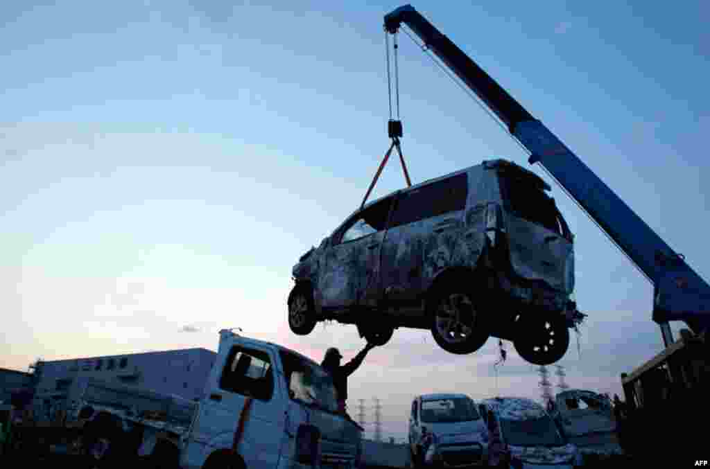 March 29: New Suzuki vehicles, destroyed by tsunami waters from the March 11 massive earthquake, are piled on the Suzuki company lot in Sendai, Japan. (AP Photo/Wally Santana)