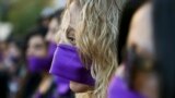 Women wear purple ribbons on their faces during the &quot;Todas en Silencio&quot; demonstration to mark the U.N.-designated International Women&#39;s Day, in front of La Moneda presidential palace in Santiago, Chile, March 8, 2017.