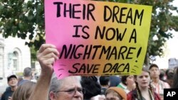 Judy Weatherly, a supporter of the Deferred Action for Childhood Arrivals (DACA), holds up a sign during a protest outside of the Federal Building in San Francisco, Sept. 5, 2017. 