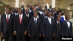 Ivory Coast's President Alassane Ouattara (C) poses with officials of his new government at the presidential palace in Abidjan, November 22, 2012. 