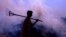 FILE - An Indian farmer walks through his paddy field as he burns the paddy husk in the northern Indian city of Chandigarh, Oct. 21, 2003. 