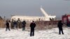 Polisi dan tim SAR di lokasi jatuhnya pesawat dekat Bandara Internasional Almaty, Kazakhstan, Jumat, 27 Desember 2019.