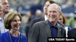 FILE - Former U.S. President George W. Bush smiles during a presentation with former first lady Laura Bush at a football game at AT&T Stadium, in Arlington, Texas, Oct 6, 2019. (Tim Heitman-USA TODAY Sports)