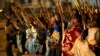 FILE - Miners on strike chant slogans as they march in Nkaneng township outside the Lonmin mine in Rustenburg.