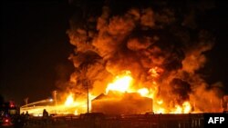 FILE - A picture taken late June 2, 2021, shows Iranian firefighters trying to extinguish an oil refinery blaze in Tehran. Other oil facility fires were reported in the Ahvaz region later in the week.