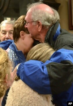 Mourners comfort one another before a prayer vigil at Briensburg Baptist Church near Benton, Ky., Jan. 23, 2018. Bailey Nicole Holt and Preston Ryan Cope, both 15, were killed and more than a dozen injured when a classmate opened fire Tuesday morning in the school's common area.
