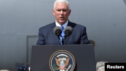 FILE - U.S. Vice President Mike Pence delivers a speech during a meeting with U.S. troops taking part in NATO led joint military exercises Noble Partner 2017 at the Vaziani military base near Tbilisi, Georgia, Aug. 1, 2017.
