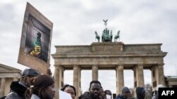 FILE - Demonstrators against dictatorship and against human rights violations in Senegal protest at the Brandenburg Gate (Brandenburger Tor) in Berlin, Germany on February 10, 2024.
