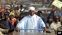 Senegalese President Abdoulaye Wade is surrounded by supporters and security as he travels between campaign stops in the suburbs of Dakar, Senegal Wednesday, Feb. 22, 2012. (AP)