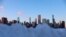 FILE - The Chicago skyline is visible Feb. 1, 2021, over heaps of snow dumped after a weekend-long winter storm hit the city. The present December 22, 2022 winter storm is expected to produce significant snowfall, even blizzards, over a wide part of the nation.. 
