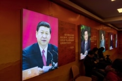 FILE - An image of China's President Xi Jinping is seen on an exhibition about the history of the Communist Party of China, in Shanghai, March 16, 2018.