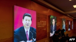 FILE - An image of China's President Xi Jinping is seen on an exhibition about the history of the Communist Party of China, in Shanghai, March 16, 2018.