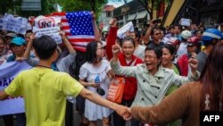 Protesters shout slogans against a proposal to grant companies lengthy land leases during a demonstration in Ho Chi Minh City, Vietnam, June 10, 2018. American William Nguyen was among protesters detained at one of the ralllies.