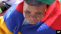 Elderly woman among thousands marching to government headquarters in festive re-enactment of famed anti-apartheid protest that addressed women's issues, Pretoria, August 2006.