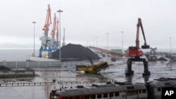 FILE - In this July 24, 2016, file photo, coal brought from Siberia is seen awaiting loading onto a ship bound for China in the North Korean special economic zone of Rason. China has long been the North Korea’s main trading partner and diplomatic protector. But Kim Jong Un’s nuclear and missile tests have alienated Chinese leaders, who supported U.N. sanctions. 
