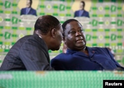Then Presidential candidate Alassane Ouattara (L) speaks to Henri Konan Bedie of PDCI during Ouattara's investiture the alliance candidate for the 2nd round of the presidential elections, in Cocody, Abidjan, Nov. 10, 2010.