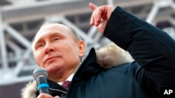 FILE - Russian President Vladimir Putin speaks during a massive rally in his support as a presidential candidate at the Luzhniki stadium in Moscow, Russia, March 3, 2018.