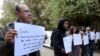 Activists hold placards that read, among others, "Giulio, one of us and killed like us," during a memorial for Giulio Regeni outside of the Italian embassy in Cairo, Egypt, Feb. 6, 2016. 