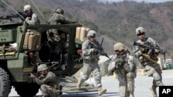 FILE - U.S. Army soldiers from the 25th Infantry Division's 2nd Stryker Brigade Combat Team and South Korean soldiers take part in an annual joint military exercise at the Rodriquez Multi-Purpose Range Complex in Pocheon, north of Seoul, South Korea.