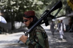 A Taliban fighter stands guard at a checkpoint in the Wazir Akbar Khan neighborhood in the city of Kabul, Afghanistan, Aug. 22, 2021.