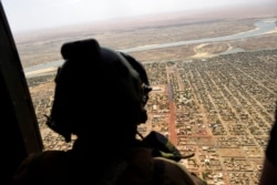 FILE - A French soldier stands inside a military helicopter in Gao, northern Mali, May 19, 2017.