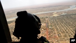 FILE - A French soldier stands inside a military helicopter in Gao, northern Mali, May 19, 2017.