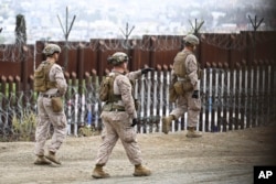 U.S. Marines deploy along the U.S.-Mexico border near the San Ysidro Port of Entry, Feb. 7, 2025, in San Diego with Tijuana, Mexico, in the background.