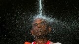 A Hindu devotee takes a ritual shower before he starts his pilgrimage to the sacred Batu Caves Temple during Thaipusam festival outside Kuala Lumpur, Malaysia. Thousands of Hindus participate in the annual thanksgiving festival in which devotees subject themselves to painful rituals in a demonstration of faith and penance held in honor of Lord Subramaniam.