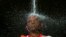 A Hindu devotee takes a ritual shower before he starts his pilgrimage to the sacred Batu Caves Temple during Thaipusam festival outside Kuala Lumpur, Malaysia. Thousands of Hindus participate in the annual thanksgiving festival in which devotees subject themselves to painful rituals in a demonstration of faith and penance held in honor of Lord Subramaniam.