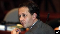 Former Colombian agricultural minister Andres Felipe Arias sits in court to face corruption charges in Bogota, Colombia, Tuesday, July 26, 2011.