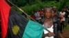 FILE - A man carries the Biafran flag during a parade in Ekwe village, near Enugu, southeastern Nigeria.