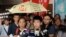 Former student leader Lester Shum, center, one of the activists found guilty of contempt of court, speaks to media at the High Court in Hong Kong, Friday, Oct. 13, 2017. 